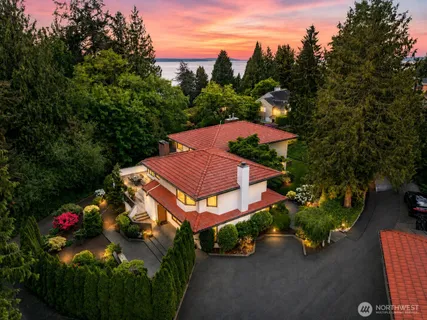 an aerial view of a house with garden space and street view