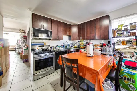 a kitchen with a refrigerator a stove a sink and a refrigerator