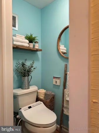 a white toilet sitting next to a bathroom sink