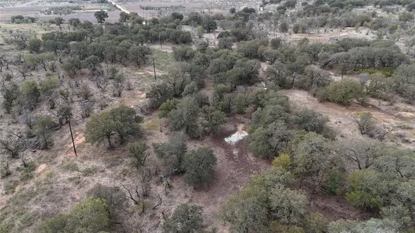a view of a field with trees in background