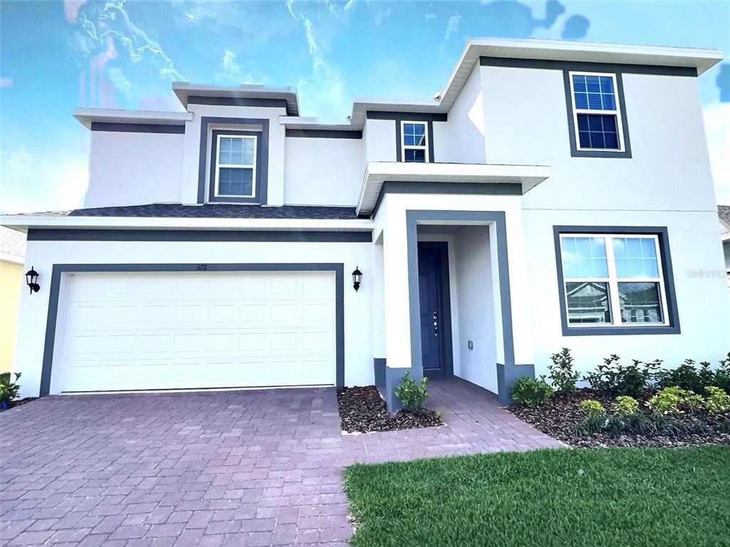 378 Switchgrass Loop Minneola, FL 34715 - Photo 1 of 37 a front view of a house with garden