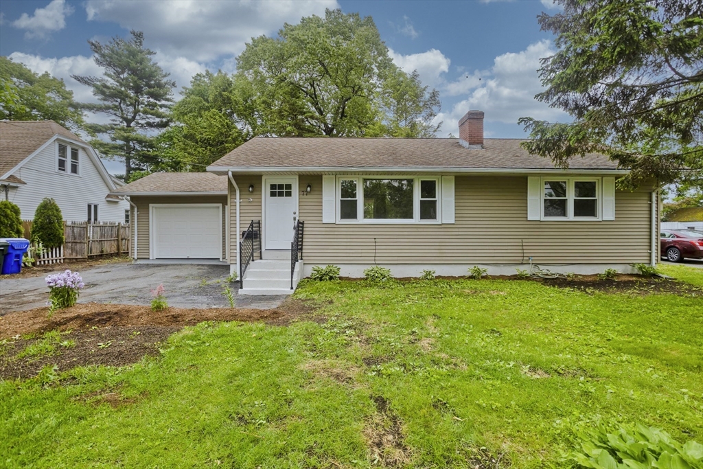 a front view of a house with a garden
