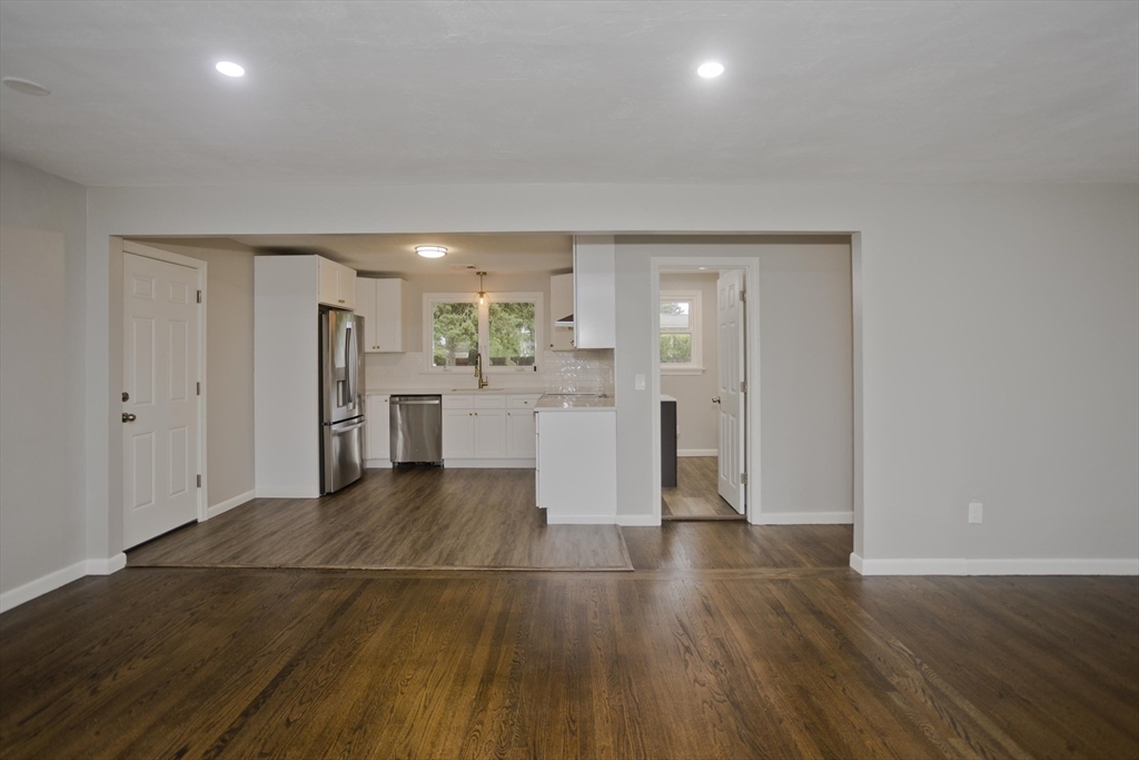 77 Drexel Street Springfield, MA 01104 - Photo 11 of 40 a view of a kitchen with wooden floor and a refrigerator