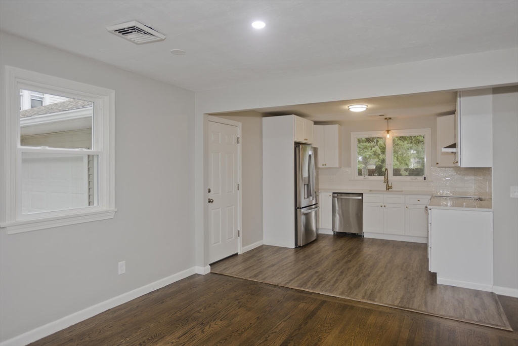 77 Drexel Street Springfield, MA 01104 - Photo 12 of 40 a kitchen with white cabinets and refrigerator