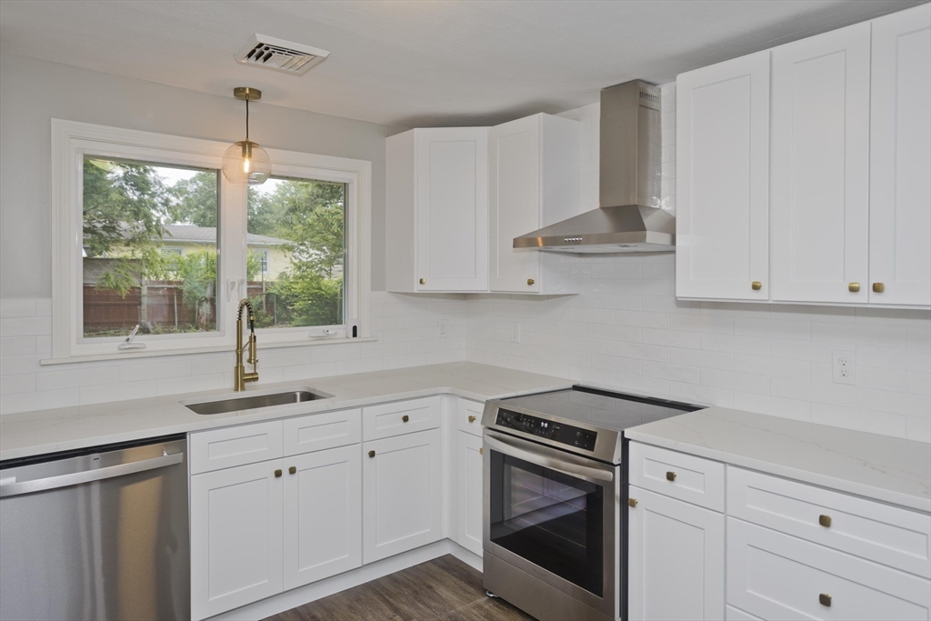 77 Drexel Street Springfield, MA 01104 - Photo 14 of 40 a kitchen with cabinets appliances a sink and a window