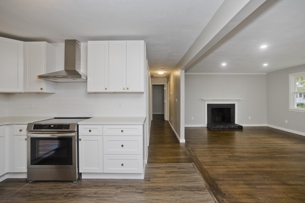 77 Drexel Street Springfield, MA 01104 - Photo 17 of 40 a kitchen with stainless steel appliances granite countertop a stove a sink and a refrigerator