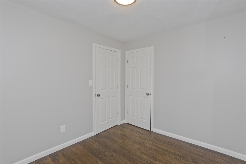 77 Drexel Street Springfield, MA 01104 - Photo 25 of 40 a view of an empty room with wooden floor