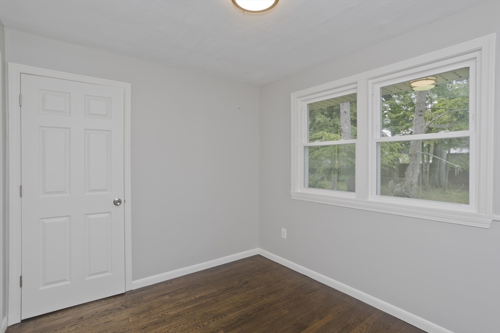 77 Drexel Street Springfield, MA 01104 - Photo 26 of 40 an empty room with wooden floor and windows