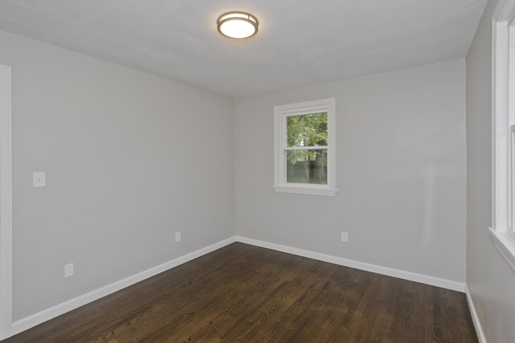 77 Drexel Street Springfield, MA 01104 - Photo 31 of 40 an empty room with wooden floor and windows