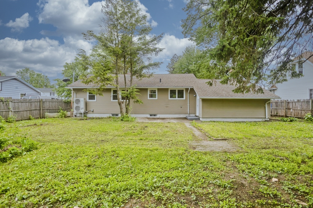 77 Drexel Street Springfield, MA 01104 - Photo 5 of 40 a backyard of a house with table and chairs