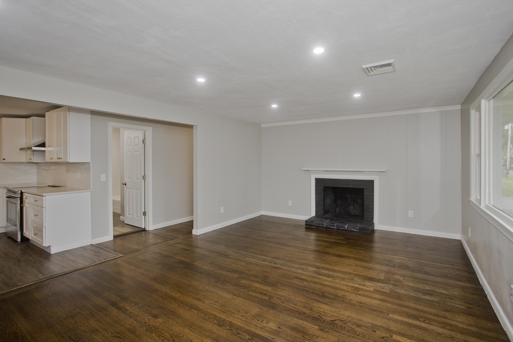 77 Drexel Street Springfield, MA 01104 - Photo 7 of 40 a view of an empty room with a window and wooden floor
