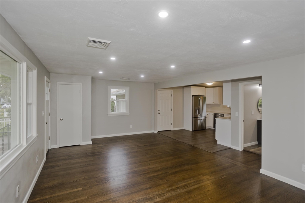 77 Drexel Street Springfield, MA 01104 - Photo 10 of 40 an empty room with wooden floor and windows