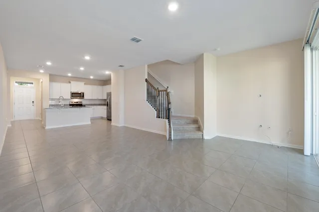 a view of a kitchen with refrigerator and a sink