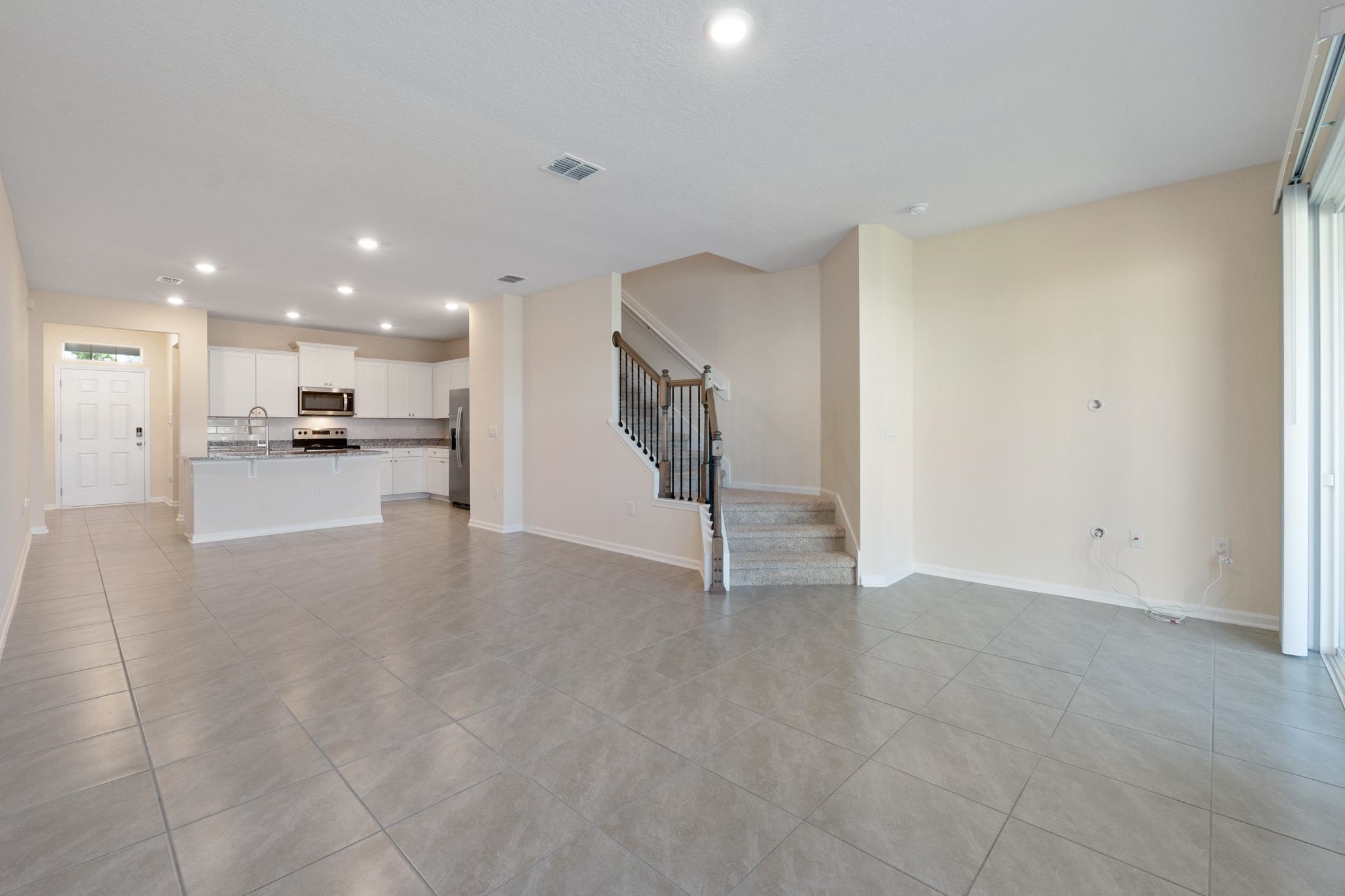 196 Redbud Road Palm Coast, FL 32137 - Photo 15 of 41 a view of a kitchen with refrigerator and a sink