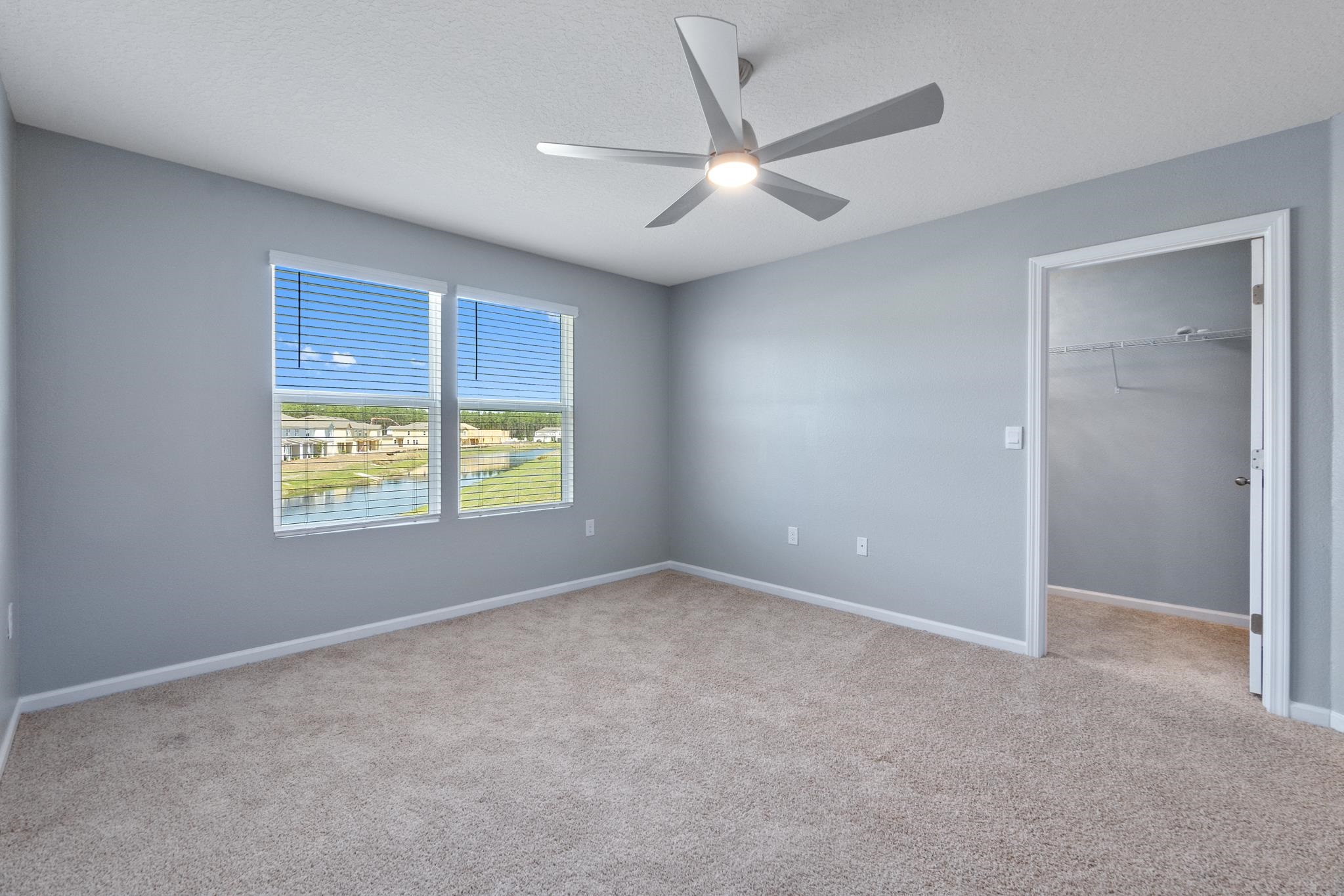 196 Redbud Road Palm Coast, FL 32137 - Photo 21 of 41 an empty room with windows and fan