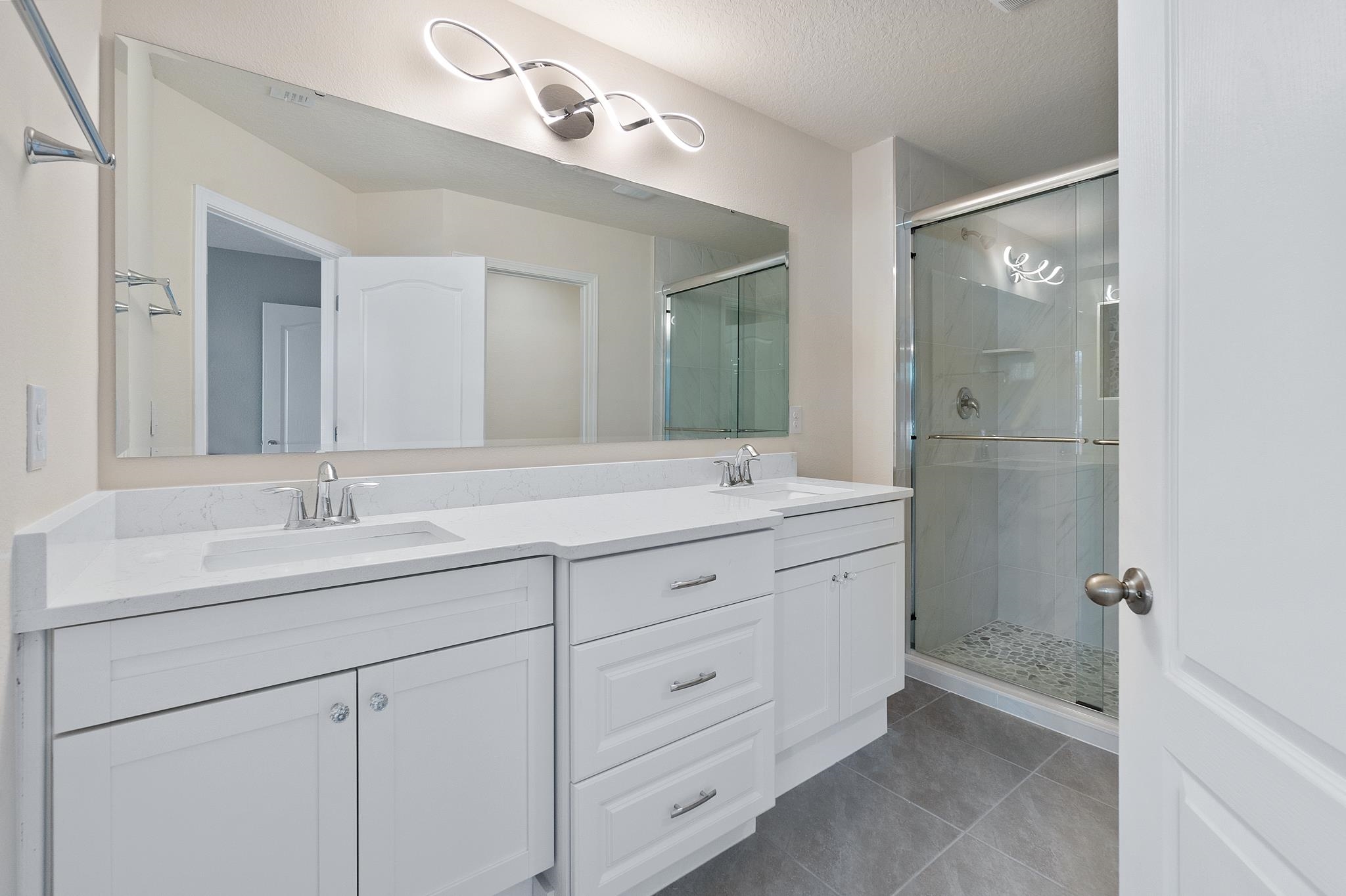 196 Redbud Road Palm Coast, FL 32137 - Photo 25 of 41 a bathroom with double sink and a mirror