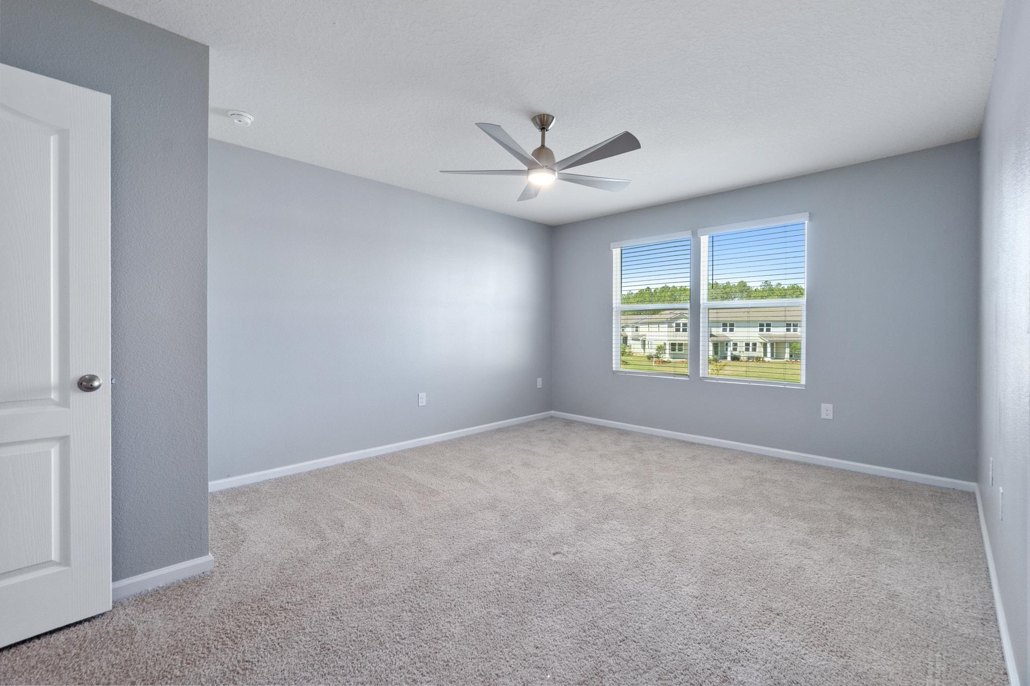 196 Redbud Road Palm Coast, FL 32137 - Photo 27 of 41 an empty room with windows and fan
