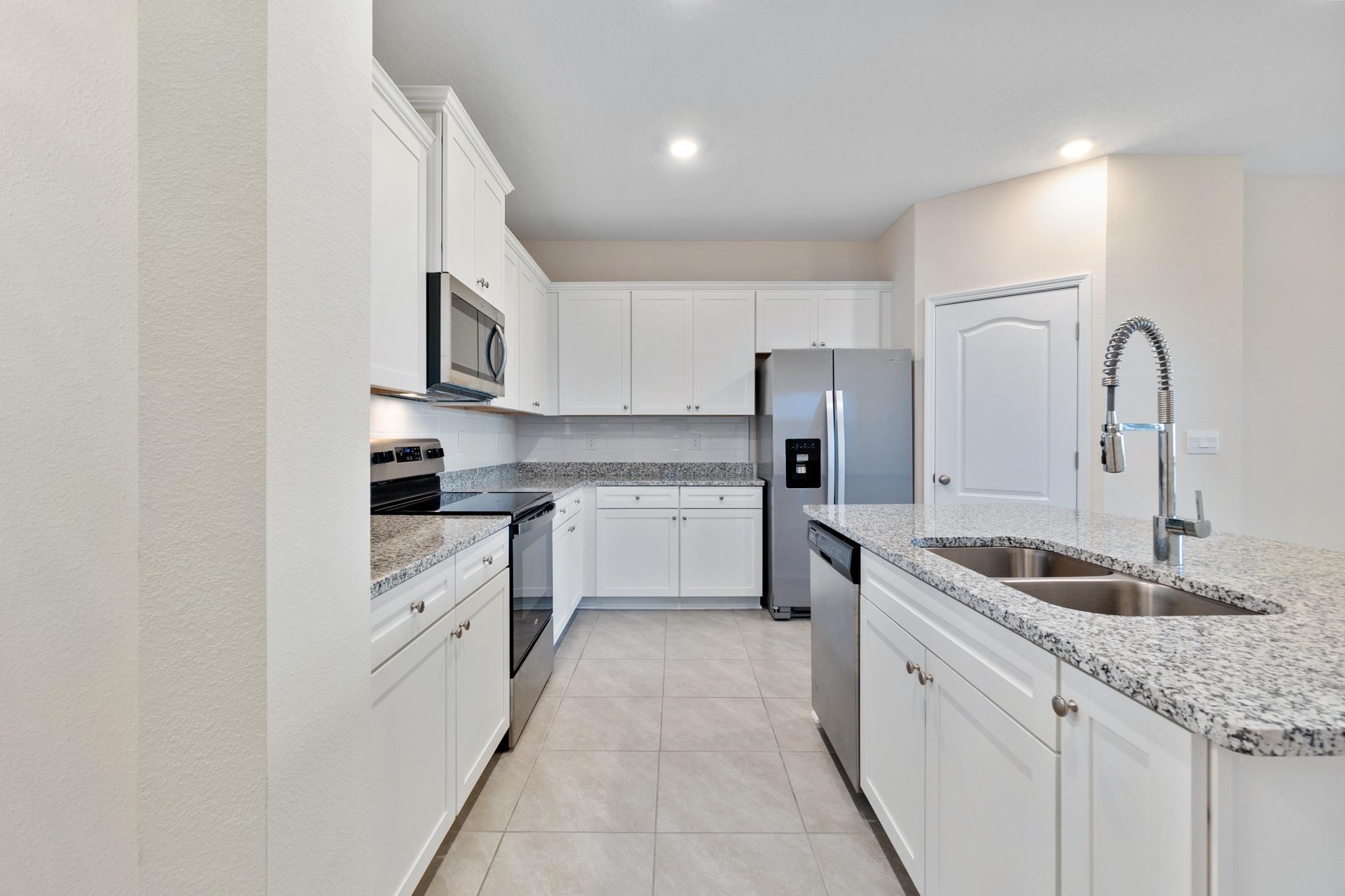 196 Redbud Road Palm Coast, FL 32137 - Photo 6 of 41 a kitchen with granite countertop a sink stainless steel appliances and cabinets
