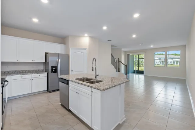 a kitchen with a sink stove and refrigerator