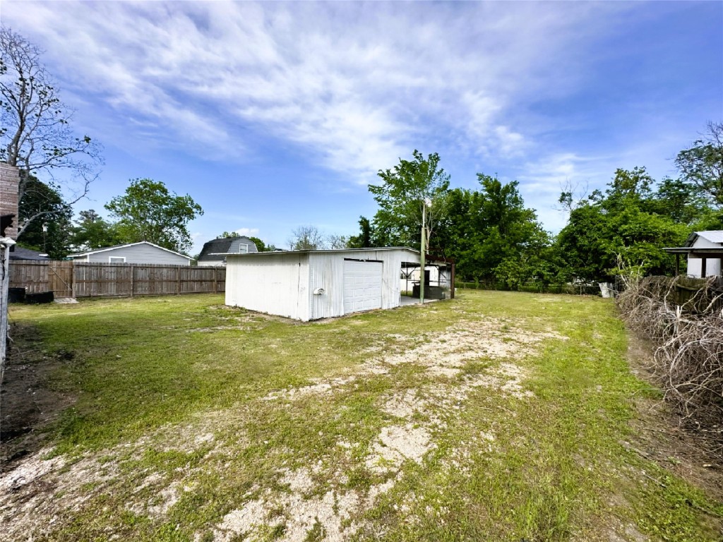 207 South 5th Street Highlands, TX 77562 - Photo 13 of 15 a backyard of a house with lots of green space