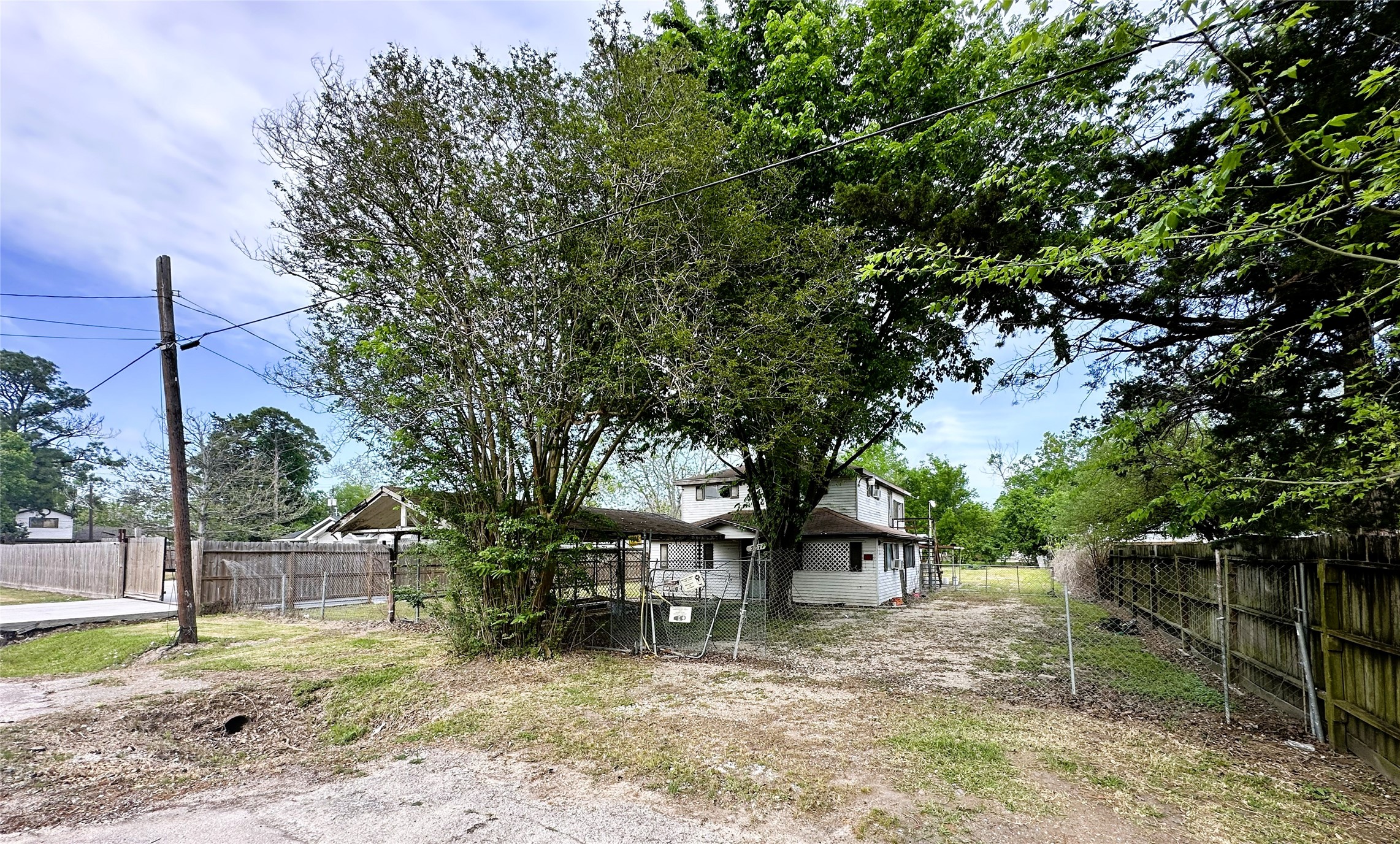 207 South 5th Street Highlands, TX 77562 - Photo 2 of 15 a backyard of a house with lots of green space