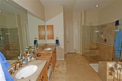 54 Vía Bella Rancho Mirage, CA 92270 - Photo 17 of 25 a bathroom with a double vanity sink mirror double shower and a mirror