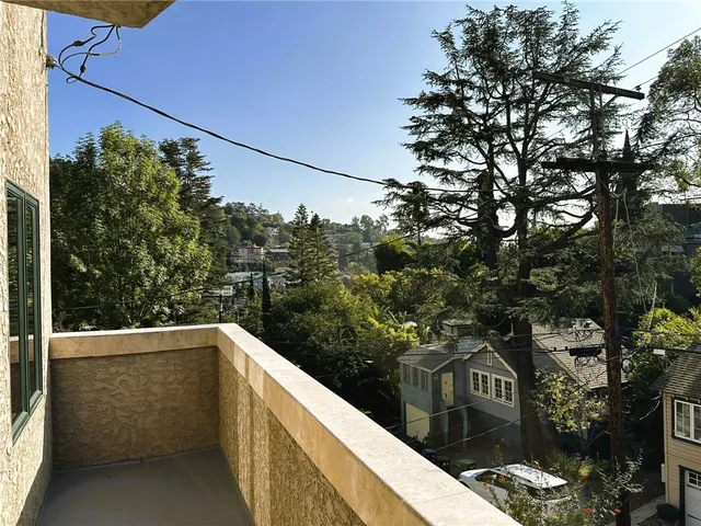 a view of a balcony with wooden fence and floor