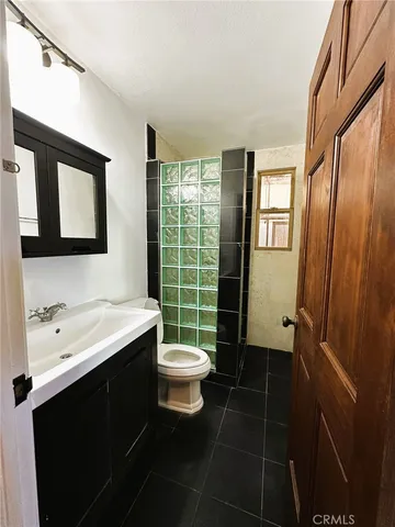 a bathroom with a sink toilet and a mirror
