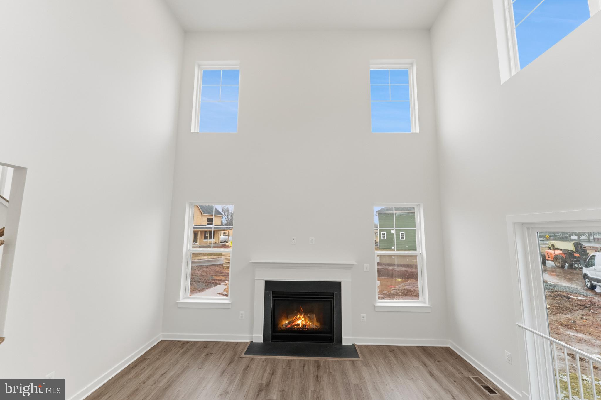 19110 Tatie Way Poolesville, MD 20837 - Photo 11 of 29 a view of an empty room with wooden floor fireplace and a window
