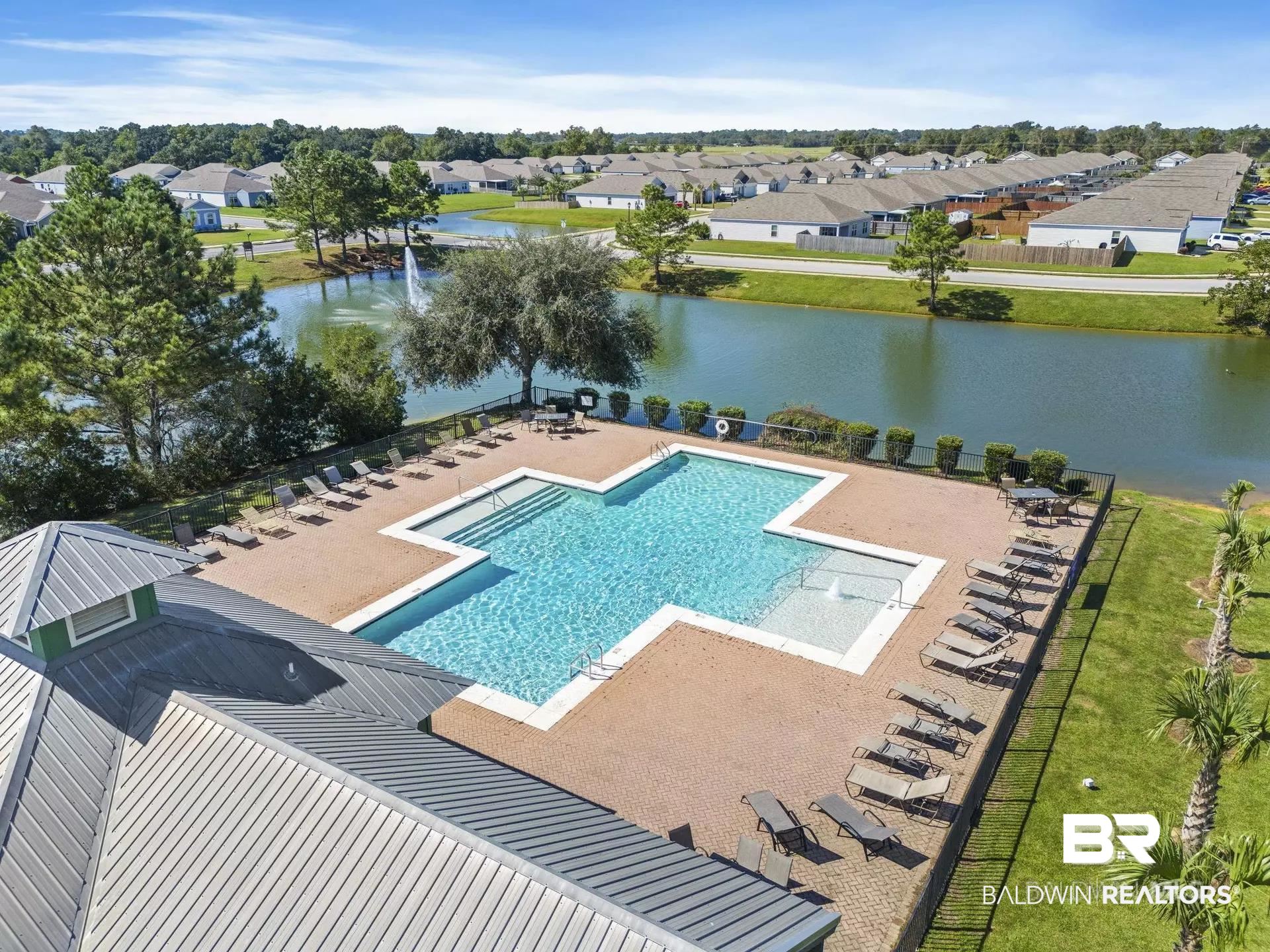 8027 Pickwick Dr. Foley, AL 36535 - Photo 36 of 37 Community pool featuring a water view, a patio, and a residential view