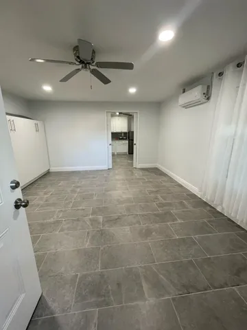 a view of a livingroom with a ceiling fan and window