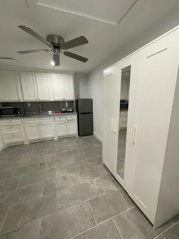 a kitchen with stainless steel appliances a refrigerator and a stove top oven