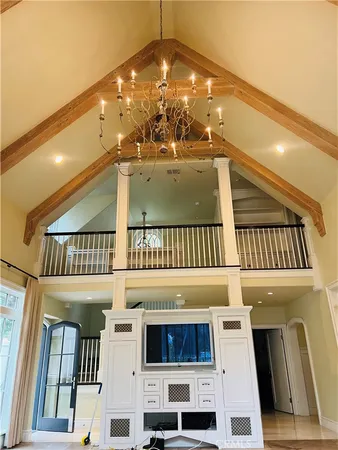 a view of an empty room with a fireplace and a chair