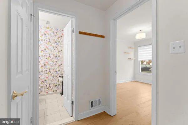 a bathroom with a granite countertop sink and a toilet