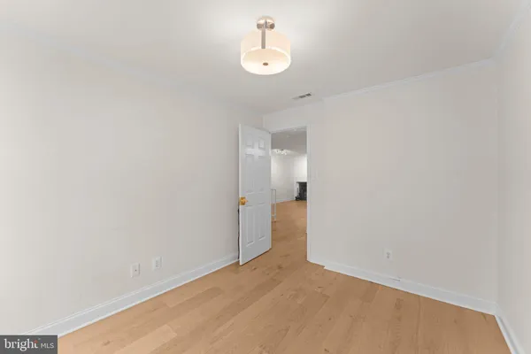 a view of main area with wooden floor and windows