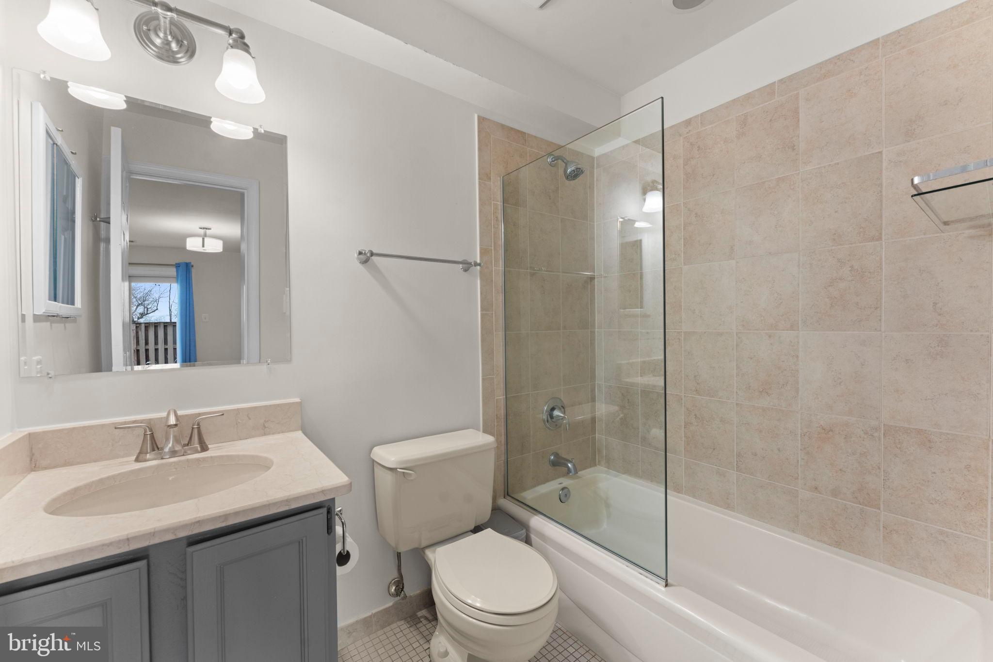 2105 North Rolfe Street, Unit A Arlington, VA 22209 - Photo 25 of 56 a bathroom with a sink a toilet and shower