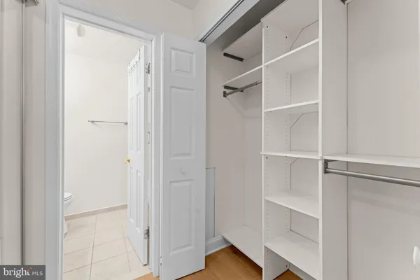 a bathroom with a granite countertop sink a toilet and a mirror
