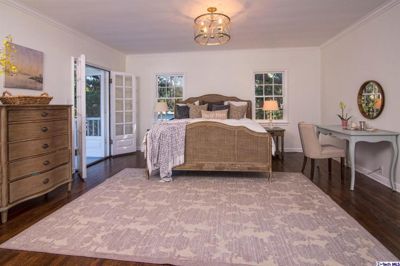 1814 Midlothian Drive Altadena, CA 91001 - Photo 20 of 42 a spacious bedroom with a bed and a table in it