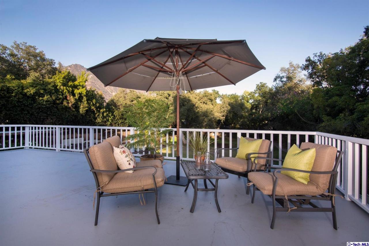 1814 Midlothian Drive Altadena, CA 91001 - Photo 24 of 42 a patio with wooden floor a yard a table and chairs