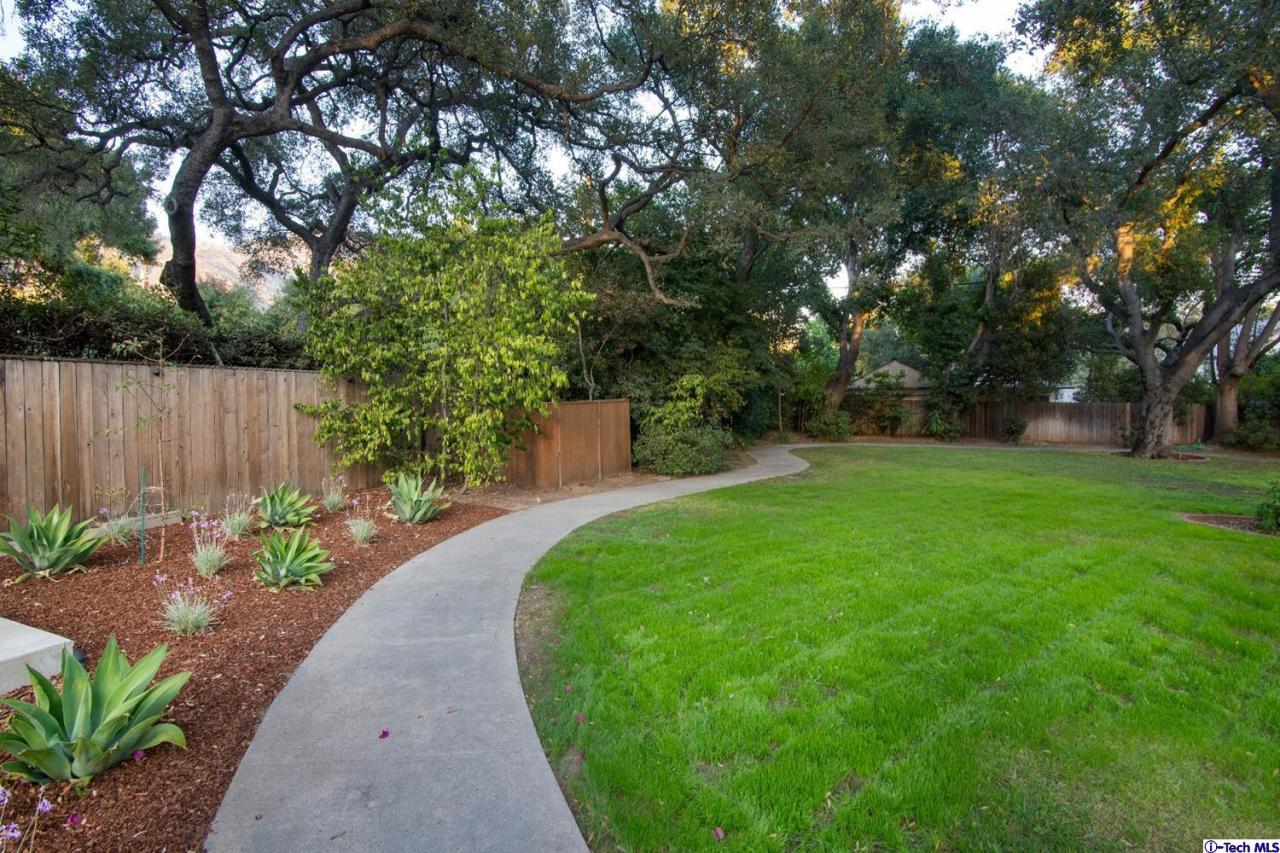 1814 Midlothian Drive Altadena, CA 91001 - Photo 36 of 42 a view of a backyard with potted plants and large trees