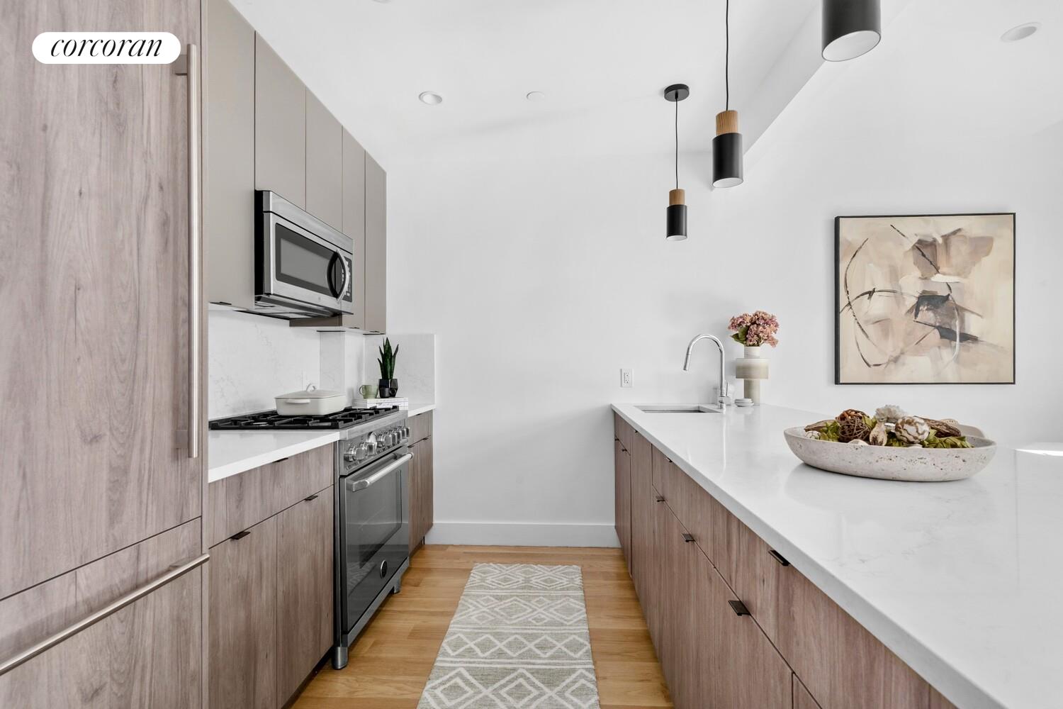 1105 Cortelyou Road, Unit 301 Brooklyn, NY 11218 - Photo 5 of 15 a kitchen with stainless steel appliances a sink stove and refrigerator