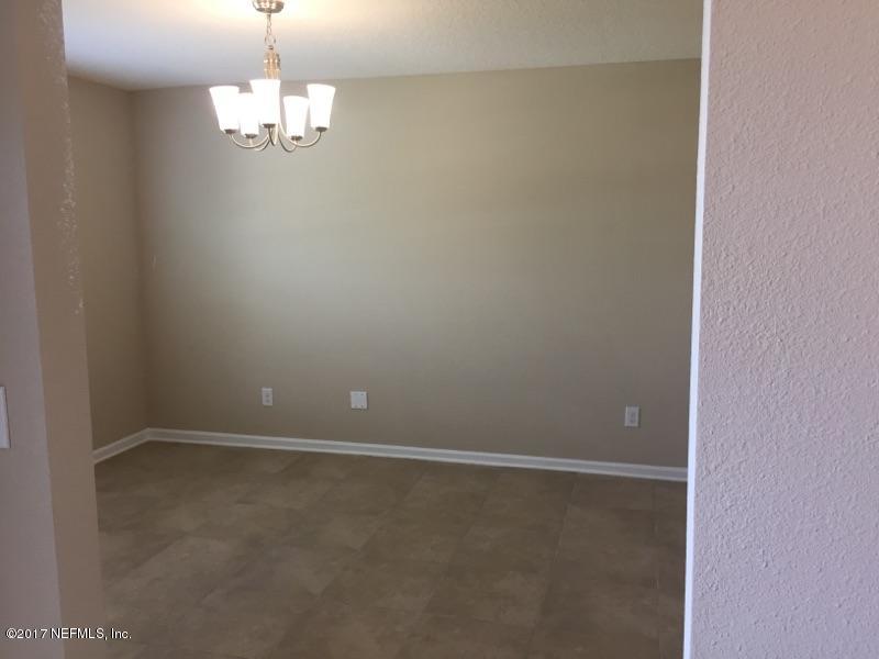 401 Deer Crossing Road St. Augustine, FL 32086 - Photo 4 of 20 a view of an empty room with a chandelier fan