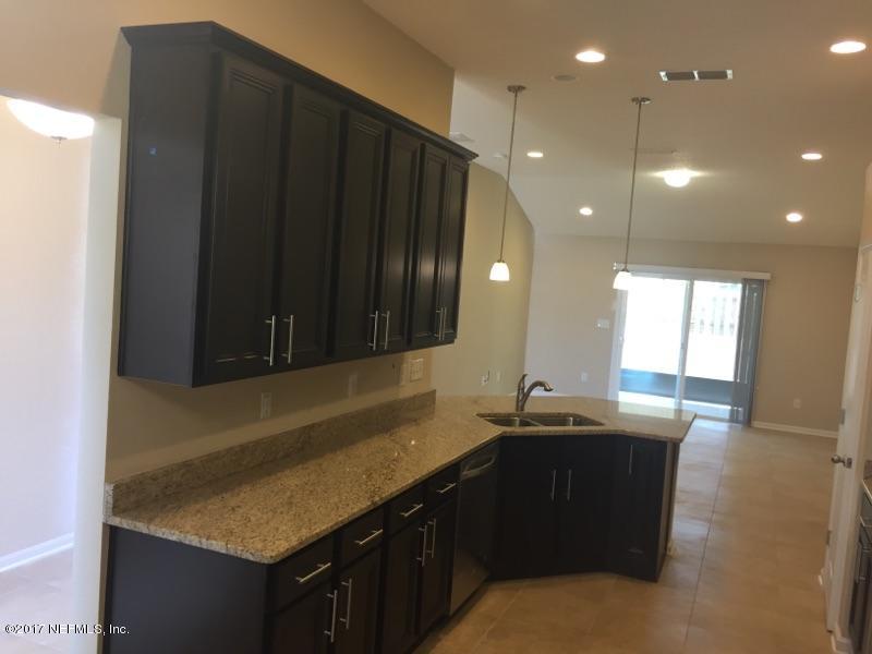 401 Deer Crossing Road St. Augustine, FL 32086 - Photo 7 of 20 a kitchen with granite countertop a sink and cabinets