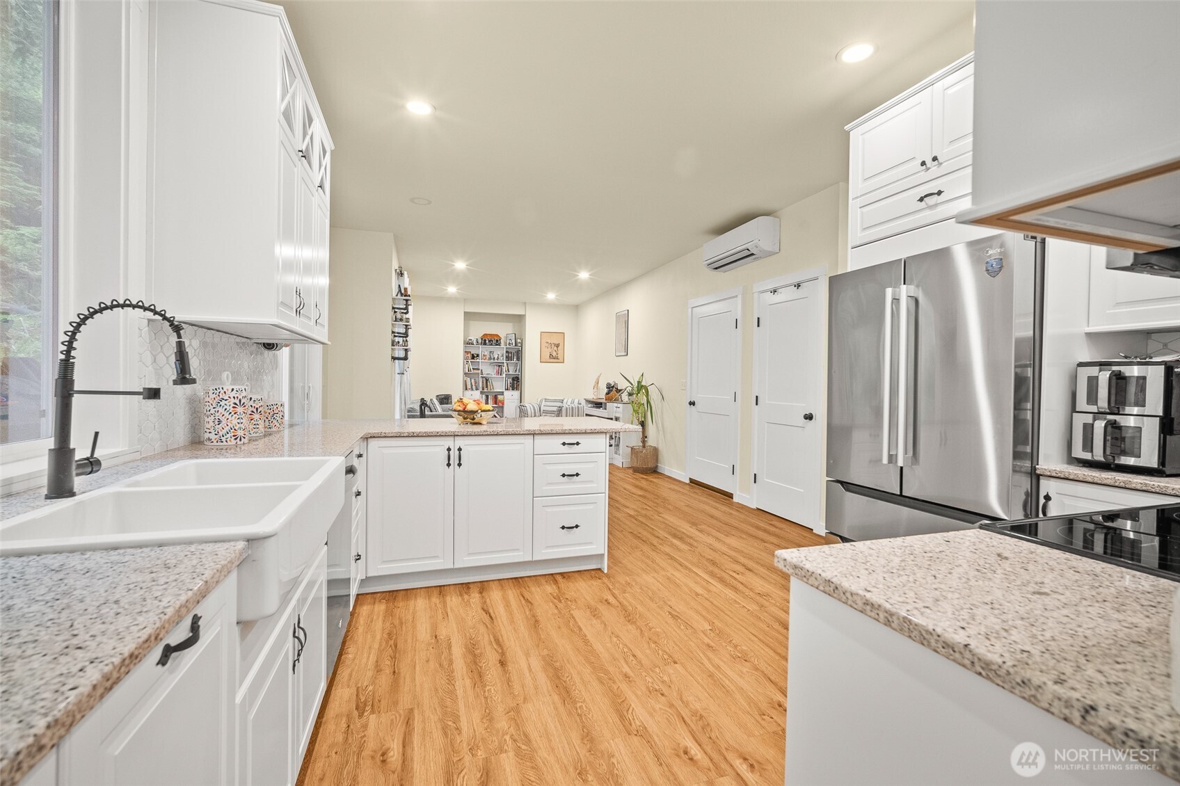 23 Spring Court Bellingham, WA 98229 - Photo 8 of 38 a large kitchen with stainless steel appliances granite countertop a lot of counter space and wooden floors