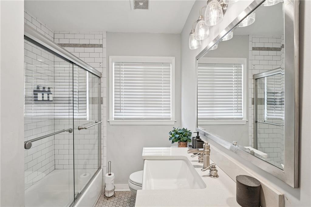 2659 Glenvalley Drive Decatur, GA 30032 - Photo 20 of 59 a bathroom with a sink a toilet a large mirror and shower