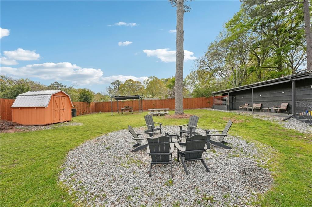 2659 Glenvalley Drive Decatur, GA 30032 - Photo 32 of 59 a view of a patio with table and chairs potted plants and a palm tree
