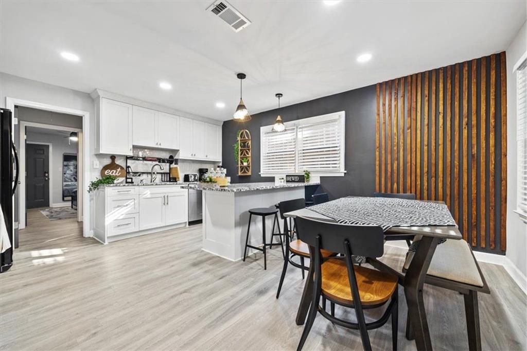 2659 Glenvalley Drive Decatur, GA 30032 - Photo 39 of 59 a open kitchen with a table chairs refrigerator and cabinets
