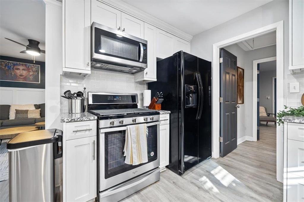 2659 Glenvalley Drive Decatur, GA 30032 - Photo 41 of 59 a kitchen with stainless steel appliances granite countertop a refrigerator stove and microwave
