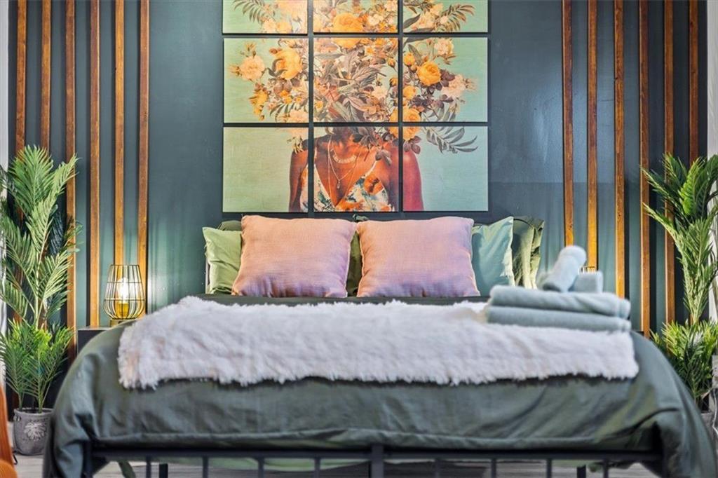 2659 Glenvalley Drive Decatur, GA 30032 - Photo 45 of 59 a bedroom with a bed and a potted plant