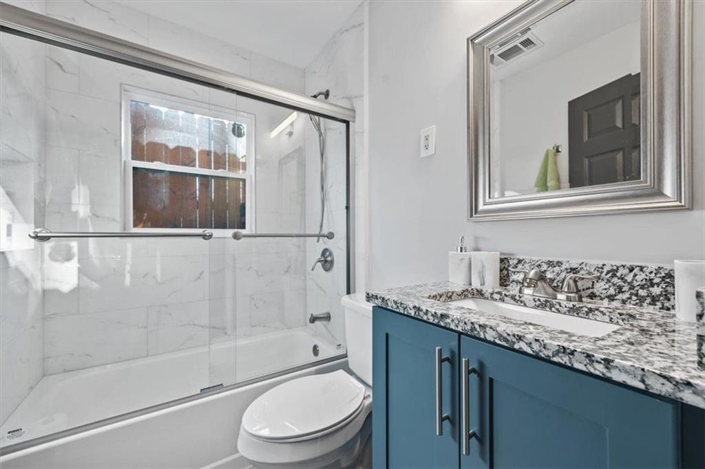 2659 Glenvalley Drive Decatur, GA 30032 - Photo 46 of 59 a bathroom with a granite countertop sink a toilet and shower